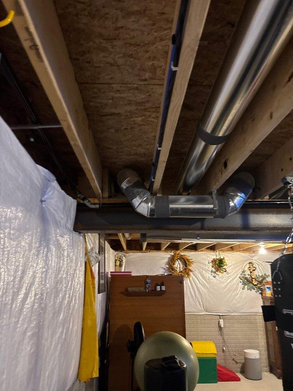 Installed dedicated 50-amp circuit for hot tub installation with load shed module for generator compatibility. Consolidated existing panel GFCI and smoke detector breakers to create two available spaces in main electrical panel. Routed new circuit through joist bay from panel, running parallel to existing ductwork and waterlines across basement ceiling to rear of residence. Installed customer-supplied disconnect at required 6-foot distance from hot tub, mounted on deck fascia board, and connected whip to hot tub control panel. All work completed per electrical code requirements with load management system integrated for generator operation.