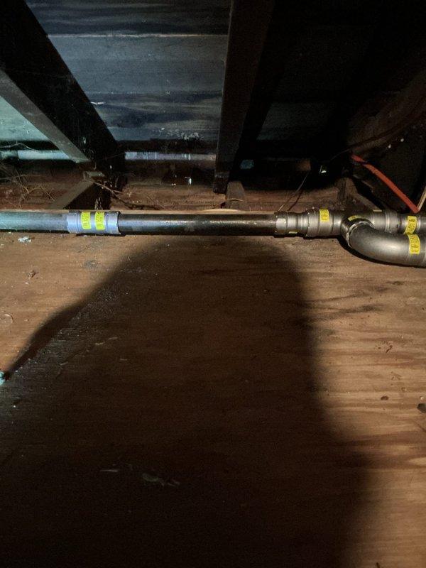 Replaced main gas line from meter in front yard to residential structure. Excavated trench from meter location to home using mechanical trencher, installed new gas line secured to exterior of building, and penetrated through garage overhang into attic space to connect with existing appliance feed lines serving boiler and water heater. Installed proper fittings and transitions in attic crawlspace to tie into existing distribution system. Backfilled excavated trench and allowed to settle. Conducted complete system pressure test to verify integrity of installation and confirmed no leaks present throughout entire gas line system.