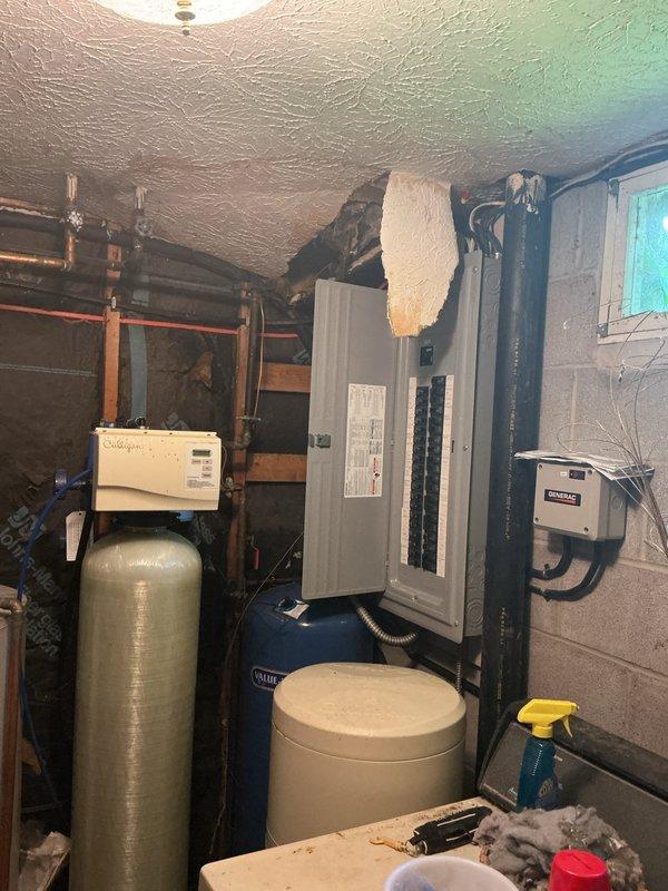 Responded to active water leak originating from upstairs toilet that was dripping through the ceiling into the basement utility room. Upon inspection, identified the source of the leak and assessed water damage to the basement ceiling and surrounding area. Performed necessary repairs to stop the active leak and prevent further water intrusion. Documented the mechanical room conditions, including existing water treatment systems, electrical panels, and plumbing infrastructure for reference. The leak was successfully resolved, and the affected area was left clean and dry.