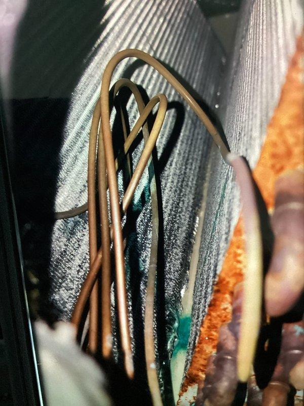 Completed scheduled MVP cooling maintenance visit on 5-year-old system at 8am appointment. Upon inspection, discovered significant corrosion and rust on evaporator coil fins and surrounding metal surfaces, along with substantial dust and mineral deposit accumulation on the coil mesh structure. Documented equipment condition with detailed photographs showing oxidation on coil assembly and discoloration throughout the heat exchanger components, indicating need for monitoring and potential future service requirements.