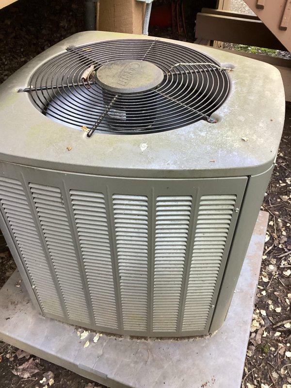 Completed scheduled MVP cooling maintenance visit on residential air conditioning system. Inspected indoor air handler unit and replaced/cleaned air filter showing moderate dust accumulation, verified proper airflow through HVAC system. Performed exterior condenser unit inspection, noting weathered cabinet finish with mineral deposits on top panel and debris accumulation around base - unit operational with fan guard intact and proper ventilation maintained through louvers.