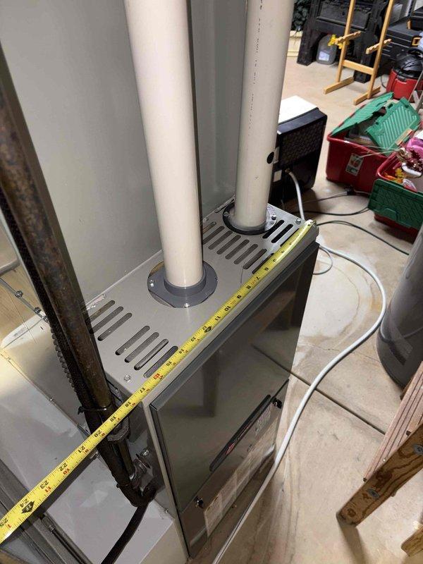 Conducted comprehensive furnace replacement estimate for residential basement installation. Assessed existing gray metal HVAC unit with white PVC venting system and evaluated ductwork connections, clearances, and accessibility requirements for future equipment replacement. Documented current system configuration including vertical venting arrangement and measured critical dimensions for proper sizing of replacement unit.