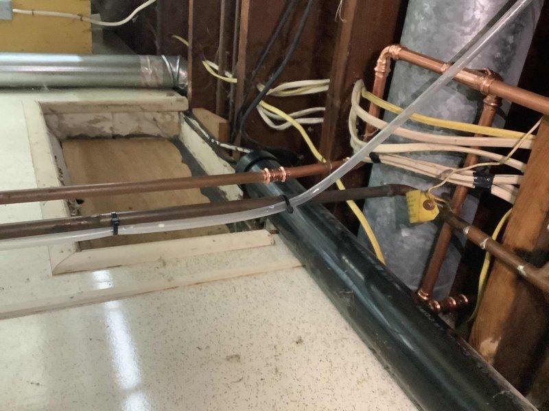 Repaired actively corroded copper water line located above the laundry sink in the basement. Replaced deteriorated washing machine supply hoses and installed new 1/2" boiler drains to prevent future leaks and water damage.