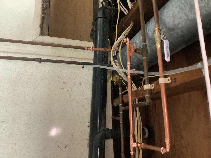 Repaired actively corroded copper water line located above the laundry sink in the basement. Replaced deteriorated washing machine supply hoses and installed new 1/2" boiler drains to prevent future leaks and water damage.