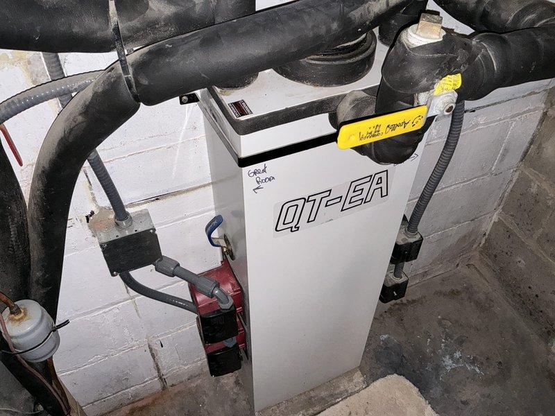 Conducted comprehensive on-site estimate for geothermal HVAC system installation. Evaluated existing mechanical room space containing QT-EA unit with multiple refrigerant lines and documented current equipment configuration, including connection points and spatial constraints. Assessed basement utility area with wooden framework structure to determine feasibility and requirements for geothermal heat pump system integration with existing infrastructure.