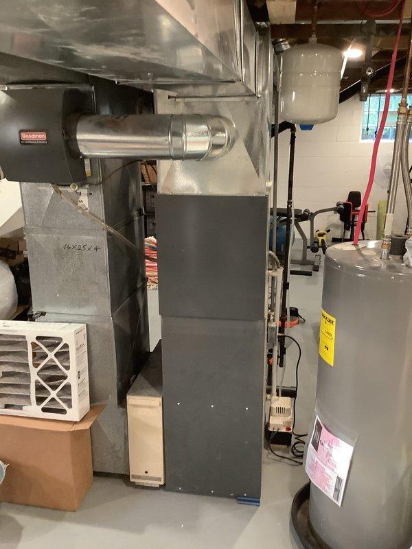 Completed installation of new Goodman air conditioning system with matching evaporator coil in residential basement mechanical room. Connected refrigerant lines, installed ductwork transitions to existing furnace plenum, completed electrical connections, and performed system startup and testing to verify proper operation.