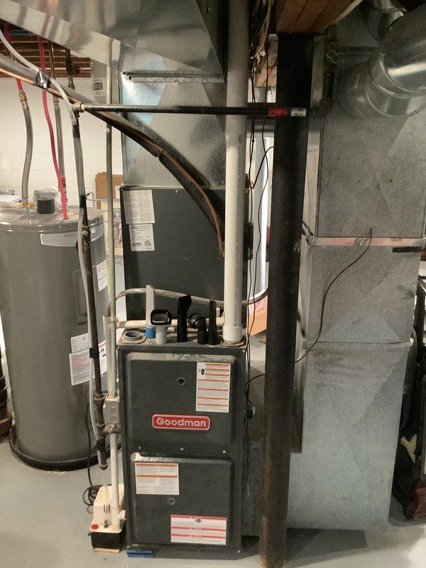 Completed installation of new Goodman air conditioning system with matching evaporator coil in residential basement mechanical room. Connected refrigerant lines, installed ductwork transitions to existing furnace plenum, completed electrical connections, and performed system startup and testing to verify proper operation.