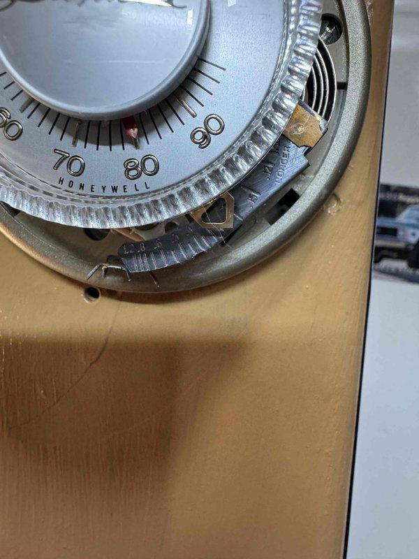 Responded to service call for boiler experiencing intermittent operation, randomly shutting off for extended periods before restarting. Inspected control board and found signs of age-related deterioration with visible discoloration and residue on circuit components. Examined Honeywell temperature control dial and associated wiring connections at pump terminal block, noting multiple wire connections including braided, orange, yellow, and blue leads. Documented condition of control board components including resistors, capacitors, rotary potentiometers, and temperature adjustment dials marked for settings ranging from 120-220 degrees. Recommended monitoring system performance and potential control board replacement due to intermittent failure pattern consistent with aging electronic components.