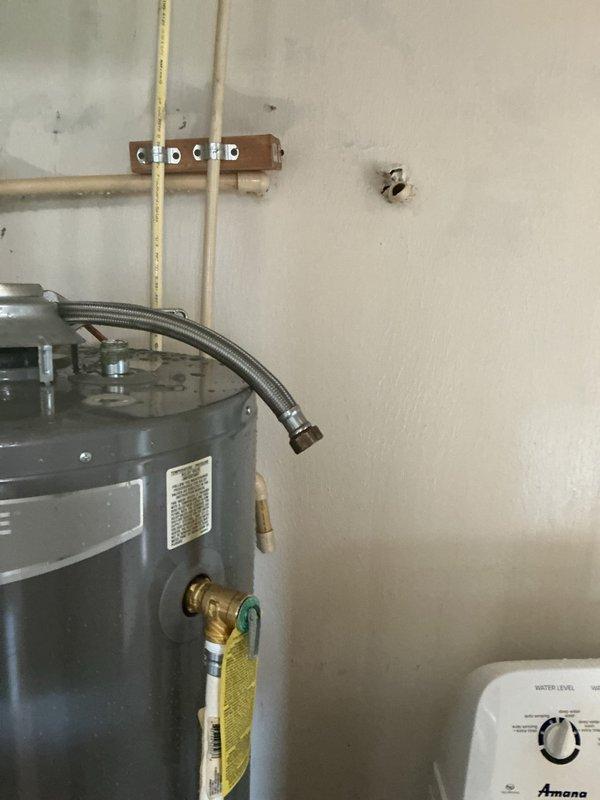 Installed a 40-gallon tall residential water heater with 6-year warranty in utility room adjacent to laundry area. Removed existing unit, connected supply and discharge lines using flexible braided connectors and copper piping, installed temperature and pressure relief valve with discharge tube, and verified all connections for proper operation and leak-free performance.
