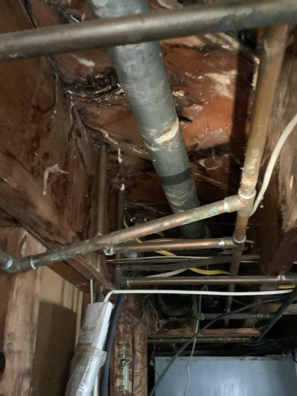 Responded to service call for bathtub drain blockage requiring snake service. Upon arrival, performed initial assessment of bathroom plumbing system and accessed drain line through tub overflow opening. Successfully deployed drain snake to clear obstruction in waste line, restoring proper drainage function. Inspected accessible plumbing infrastructure in crawl space above bathroom, documenting existing PVC waste lines, copper supply lines, and overall plumbing configuration for customer records.