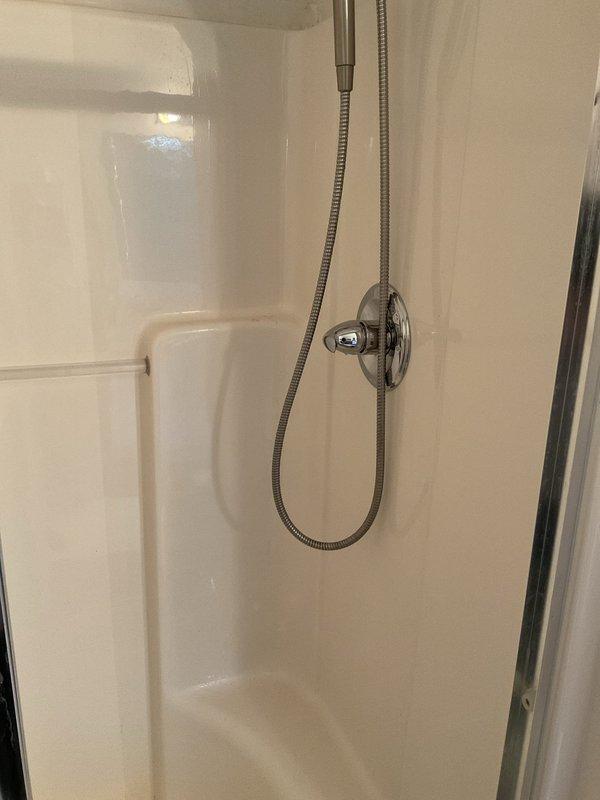 Replaced defective shower cartridge in master bathroom after sawing off damaged handle that prevented standard removal. Installed new trim kit upon completion of cartridge replacement to restore full functionality and appearance of the shower valve assembly.