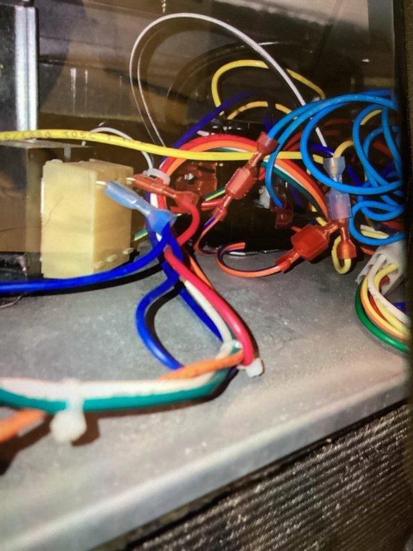 Responded to a cooling system service call and performed diagnostic inspection of the outdoor condenser unit and internal electrical components. Upon arrival, accessed the unit's control panel to inspect wiring connections, terminal blocks, and capacitor. All electrical connections were secure and properly terminated. Verified the outdoor condenser unit's condition, noting clean coil surfaces and unobstructed airflow through both upper and lower grille sections. System operational and functioning within normal parameters. Service call dismissed after confirming no immediate repairs were required.