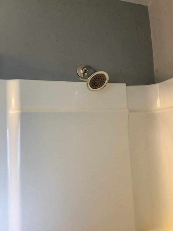 Replaced second floor tub shower faucet with new Moen Eva trim assembly, including installation of new shut-off valves accessed through wall panel. Removed existing waste and overflow assembly and installed new lift and turn style drain system. All copper supply lines and brass compression fittings properly secured, tested system for leaks, and verified proper operation of all components.