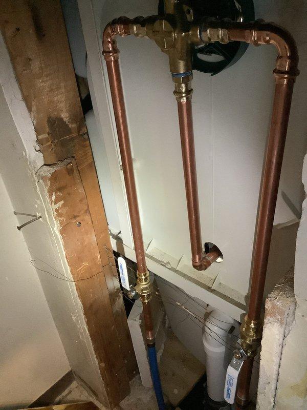 Replaced second floor tub shower faucet with new Moen Eva trim assembly, including installation of new shut-off valves accessed through wall panel. Removed existing waste and overflow assembly and installed new lift and turn style drain system. All copper supply lines and brass compression fittings properly secured, tested system for leaks, and verified proper operation of all components.