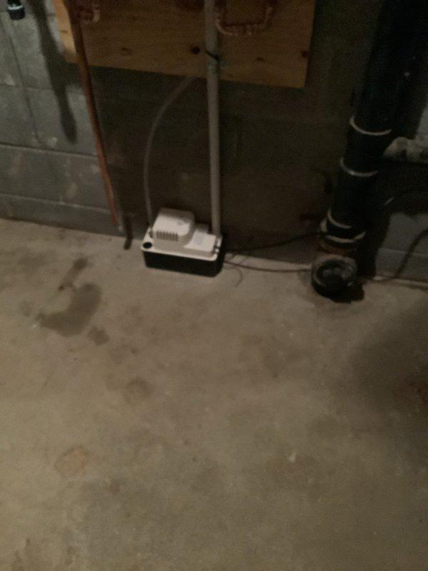 Completed installation of Navien tankless water heater unit in basement utility area. Mounted unit securely to concrete block wall and connected all necessary plumbing lines including hot and cold water supply pipes with proper insulation. Installed PVC venting system from top of unit, integrated copper piping with shutoff valves, and verified all connections for proper seal and operation. Unit powered on successfully with digital display functioning and showing operational status, confirming system is ready for use.