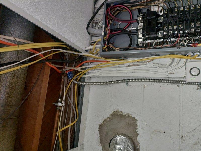 Completed electrical wiring installation for new septic system by running circuit from main electrical panel to exterior location. Installed new circuit breaker in panel, routed multi-conductor cable through wall penetration using flexible metal conduit, and secured all connections per code requirements. All wiring properly terminated and system tested for proper operation.