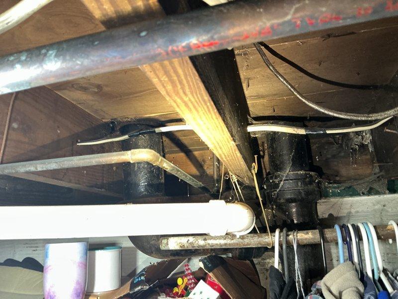 Responded to service call for toilet malfunction in 40-year-old residential property where customer suspected a urinal cap obstruction in the bowl trapway. Upon arrival, conducted thorough inspection of the affected toilet and documented existing plumbing infrastructure conditions. Assessed water heater installation and basement utility systems during diagnostic evaluation to determine if additional plumbing issues were contributing to the reported problem.