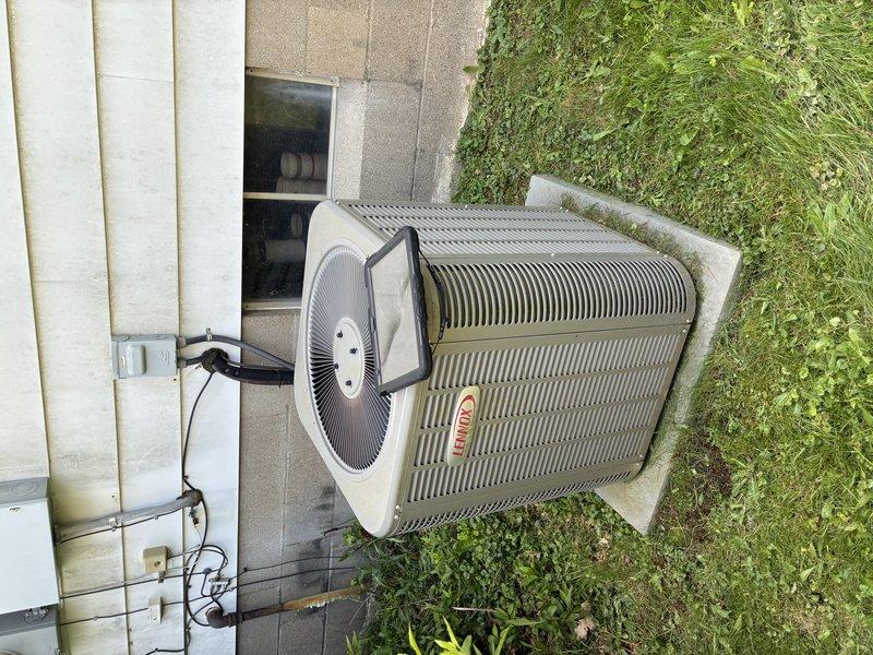 Completed preventive maintenance tune-up on 8-year-old Lennox air conditioning system. Inspected outdoor condenser unit, verified proper operation of all components, and checked electrical connections at disconnect box. Accessed indoor air handler and inspected blower assembly, noting moderate dust and lint accumulation on squirrel cage blower wheel fins that could impact airflow efficiency. Evaluated ductwork system for potential cleaning needs based on visible debris in blower compartment.