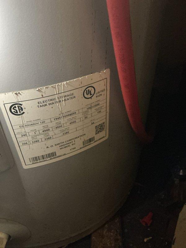 Conducted on-site assessment for tankless electric water heater installation in manufactured home. Evaluated existing electric storage tank water heater system, documented current plumbing configuration including PVC supply lines with brass compression fittings and shut-off valve, and assessed electrical requirements for conversion from conventional storage unit to tankless system. Photographed existing installation to determine necessary modifications for tankless unit compatibility and provided comprehensive estimate for equipment and installation.