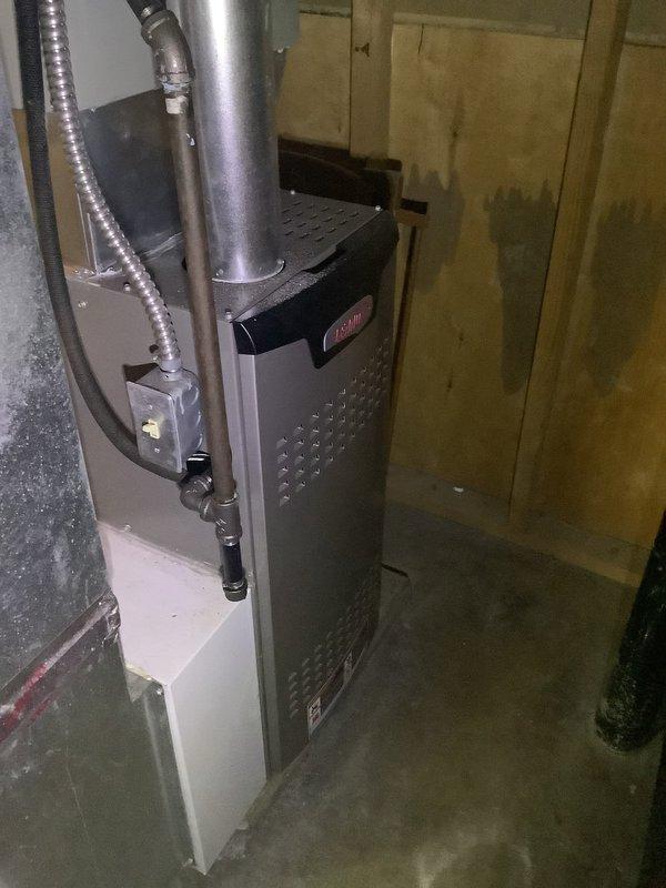 Performed preventive maintenance on 13-year-old Trane air conditioning system and furnace unit. Completed standard tune-up procedures including inspection of outdoor condenser unit, verification of electrical connections at disconnect box, and assessment of indoor furnace cabinet and flue pipe connections. All components found operating within normal parameters with no immediate service needs identified.