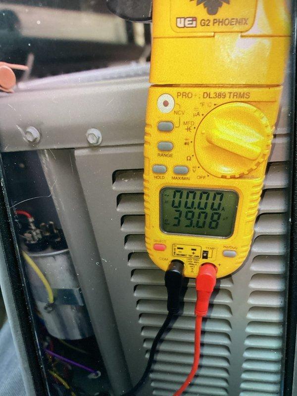 Completed comprehensive AC tune-up on 8-year-old air conditioning system. Performed electrical diagnostics using digital multimeter to verify proper voltage and amperage readings across system components, measuring 33.08 volts at control board. Inspected control panel circuit boards, wiring connections, and terminal blocks for signs of wear or damage. All electrical connections found secure, control boards functioning properly, and system operating within normal parameters for unit age.