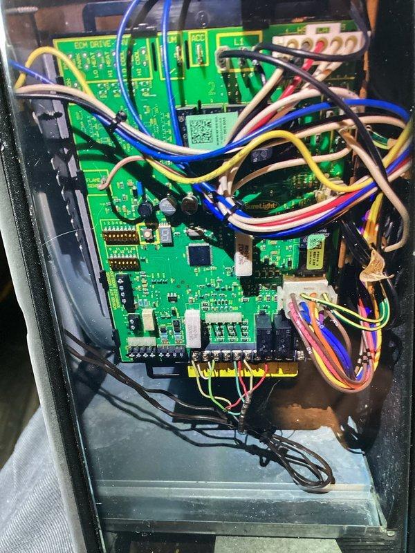 Completed comprehensive AC tune-up on 8-year-old air conditioning system. Performed electrical diagnostics using digital multimeter to verify proper voltage and amperage readings across system components, measuring 33.08 volts at control board. Inspected control panel circuit boards, wiring connections, and terminal blocks for signs of wear or damage. All electrical connections found secure, control boards functioning properly, and system operating within normal parameters for unit age.