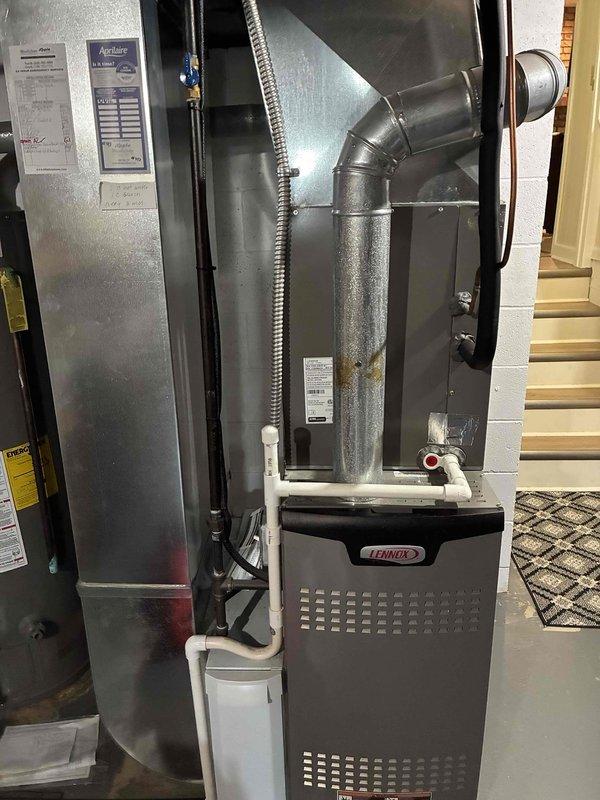 Completed scheduled cooling maintenance on 9-year-old Lennox HVAC system. Performed comprehensive inspection of furnace and air handler unit, verified proper operation of all components, checked refrigerant temperatures with digital thermometer showing -8.9°F reading, inspected condensate drainage lines and PVC venting, and documented equipment condition with photographs for maintenance records.