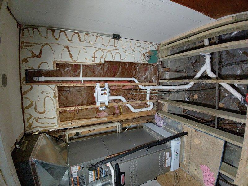 Completed full drain line installation for bathroom renovation, including all new PVC drain piping properly supported throughout the run. Installed new toilet flange, shower trap with trim kit left accessible for future tub installation, and complete lavatory drain assembly. Added new washer box installation to accommodate laundry connections in the renovated space.