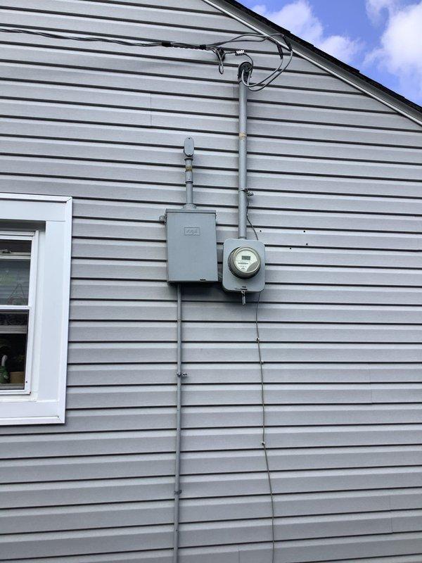 Completed full electrical service replacement on residential property. Installed new 100A, 30-space main electrical panel with exterior service entrance equipment, including SE cable wiring, meter base, weatherhead, and conduit system secured to exterior siding. Added dedicated circuit for AC/heat pump unit and verified all connections meet code requirements.