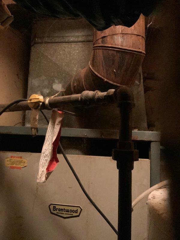 Completed comprehensive estimate for furnace and air conditioning system replacement. Assessed existing HVAC equipment and ductwork configuration in basement mechanical room, including water heater proximity and current ventilation register placement. Documented existing system components, copper ductwork routing, and utility connections to provide accurate replacement specifications for new heating and cooling equipment installation.