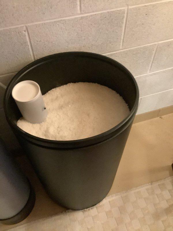 Delivered and stocked water softener salt supply to utility room. Placed multiple bags of solar salt adjacent to water softener tank and refilled brine tank with salt pellets to ensure proper system operation and continuous water treatment capability.