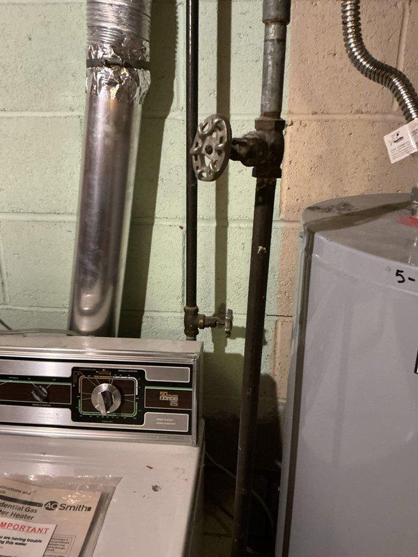 Responded to diagnostic service call for gas valve issue on water heater. Upon inspection, identified malfunctioning gas valve requiring replacement. Assessed existing gas piping configuration and water heater connections in basement utility area. Documented current system setup including gas line valve assembly and water heater control panel. Completed diagnostic evaluation and photographed equipment for quote preparation. Customer requires pricing for new gas valve installation to restore proper operation.