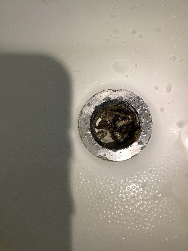 Responded to service call for slow-draining shower. Upon arrival, inspected bathtub drain and confirmed reduced water flow due to buildup and debris accumulation in the drain assembly. Cleared obstruction from drain strainer and tested water flow to verify proper drainage was restored.