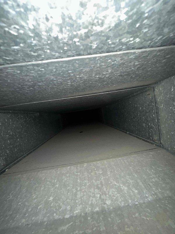 Completed comprehensive duct cleaning service for residential HVAC system covering up to 14 vents. Pre-service inspection revealed significant accumulation of dust, debris, and particulate matter throughout the ductwork, particularly concentrated along ceiling surfaces and wall transitions. Utilized professional duct cleaning equipment to remove built-up contaminants from all accessible ductwork sections, improving air quality and system efficiency.
