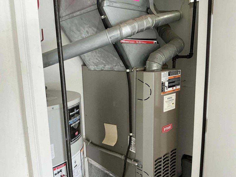 Completed comprehensive HVAC system replacement including installation of new Bryant furnace in interior mechanical room and matching outdoor condensing unit. The indoor unit was properly positioned with connected ductwork and venting, while the exterior condenser was mounted on gravel pad with appropriate clearances, refrigerant line connections, electrical conduit, and drainage considerations per manufacturer specifications.