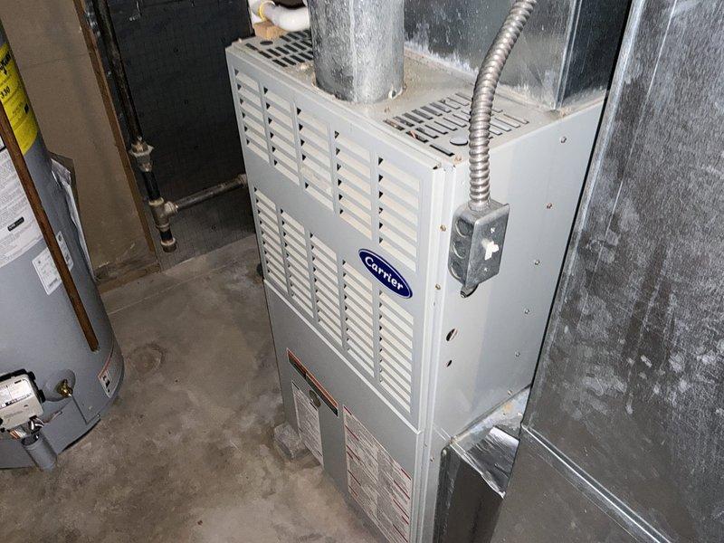 Provided comprehensive estimate for replacement of 23-year-old gas furnace and air conditioning system with confirmed refrigerant leak in existing AC unit. Assessment included evaluation of current Carrier furnace installation, inspection of ductwork showing significant condensation issues, and discussion of additional equipment options including humidifier and salt-free water softening system to address customer's specific requirements.