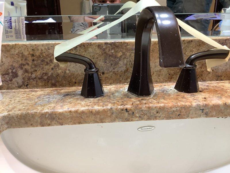 Responded to leaking faucet issue in 20-year-old home with Moen two-handle bathroom fixtures. Diagnosed failed flexible supply line with broken plastic end fitting causing water flow between handles. Replaced damaged braided stainless steel supply line with new flexible connector and installed functional shut-off valves under sink to provide proper water control. Verified all connections secure, tested for leaks, and confirmed proper operation of faucet assembly upon completion.