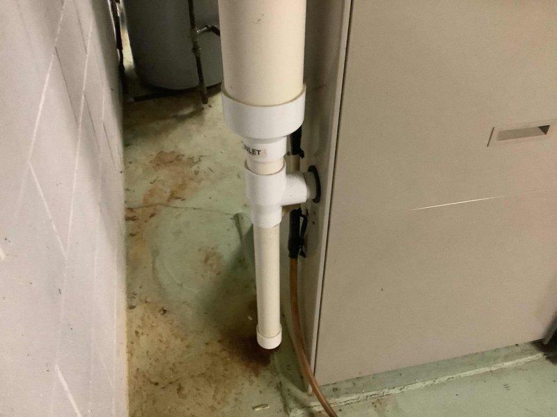 Completed comprehensive plumbing assessment of residential property with original 1958 plumbing system in preparation for sale. Inspected and documented all accessible plumbing infrastructure including basement utility areas, exposed piping systems, water heater installation, and drainage components. Observed yellow-insulated piping, PVC drain lines with multiple fittings, copper supply lines, and evidence of previous water staining on utility room flooring indicating potential past leak history that should be disclosed to prospective buyers.