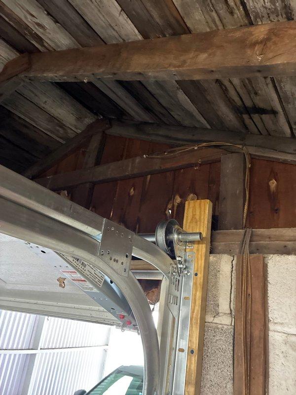 Provided comprehensive quote for installation of exterior electrical outlets and complete garage wiring replacement. Conducted thorough assessment of existing electrical infrastructure in garage and attic space, identifying aged wiring systems requiring replacement. Evaluated HVAC ductwork proximity and structural beam locations to determine optimal routing for new electrical circuits. Documented existing conditions including exposed wiring along wooden structural elements and current electrical panel configuration to develop scope of work for safe, code-compliant installation.