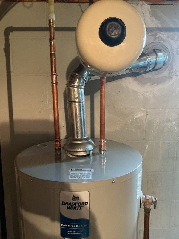 Replaced failed 2018 Rheem 40-gallon short water heater with new Bradford White 40-gallon short unit featuring 6-year manufacturer warranty. Installation included thermal expansion tank, updated gas line shut-off valve, and new drain pan with discharge line routed to existing sump crock alongside furnace condensation drain. All plumbing connections completed with proper copper piping, pressure relief components, and code-compliant fittings. System tested and operational upon completion.