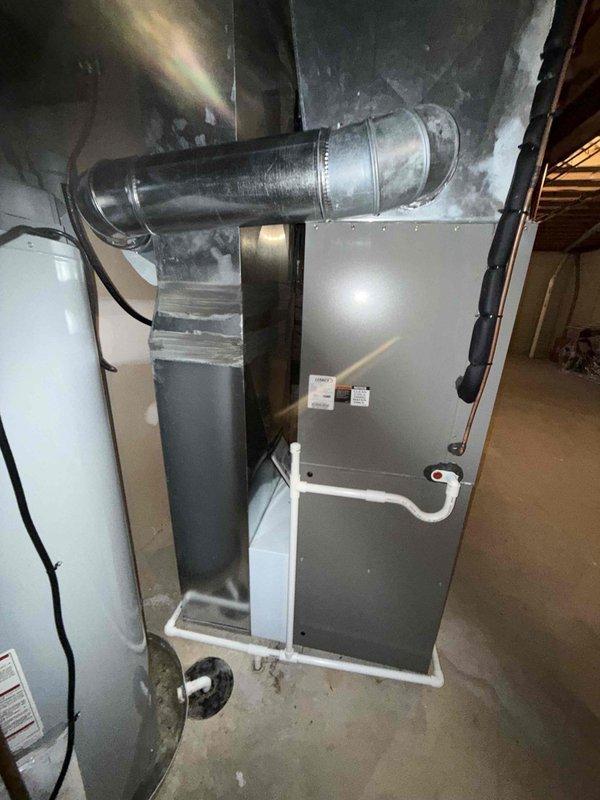 Completed preventive maintenance cooling visit on 8-year-old HVAC system. Inspected air handler unit, ductwork, and associated components in basement mechanical room. System operational with no immediate cooling concerns identified. Noted corrosion on copper plumbing near water heater and moisture staining on concrete floor, which may require monitoring for potential condensate drainage issues.