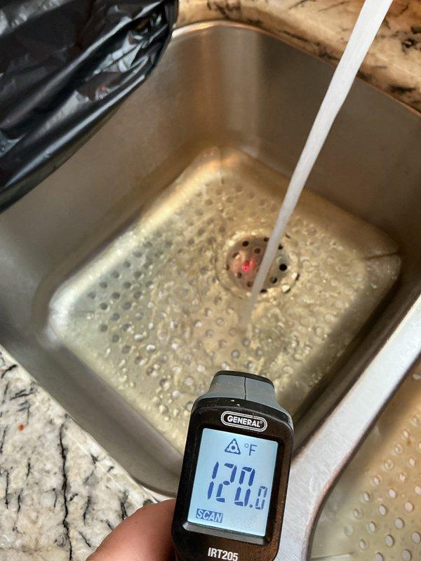 Responded to complaint regarding recently installed kitchen faucet delivering only scalding hot water in 40-year-old home. Verified water heater temperature was properly set at 120°F using infrared thermometer at multiple fixtures. Confirmed issue was isolated to the new kitchen faucet installation, with other plumbing fixtures delivering appropriately tempered water. Documented temperature readings and conditions for potential warranty claim or callback resolution.