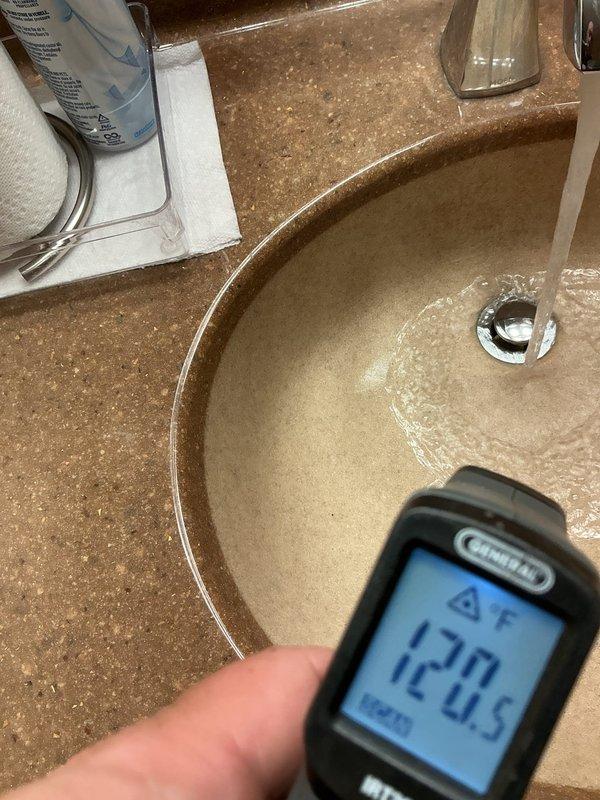 Responded to complaint regarding recently installed kitchen faucet delivering only scalding hot water in 40-year-old home. Verified water heater temperature was properly set at 120°F using infrared thermometer at multiple fixtures. Confirmed issue was isolated to the new kitchen faucet installation, with other plumbing fixtures delivering appropriately tempered water. Documented temperature readings and conditions for potential warranty claim or callback resolution.