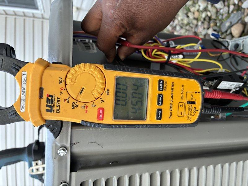 Completed annual MVP cooling maintenance visit on one-year-old system. Performed comprehensive electrical diagnostics using digital clamp meter to measure amperage draw and verify proper system operation. Inspected control board wiring connections, including power supply lines and low-voltage control circuits. All electrical connections found secure with proper wire routing through conduit. System operating within normal parameters with amperage readings at 33.73 amps, indicating appropriate compressor and condenser fan motor performance. No deficiencies noted during inspection.