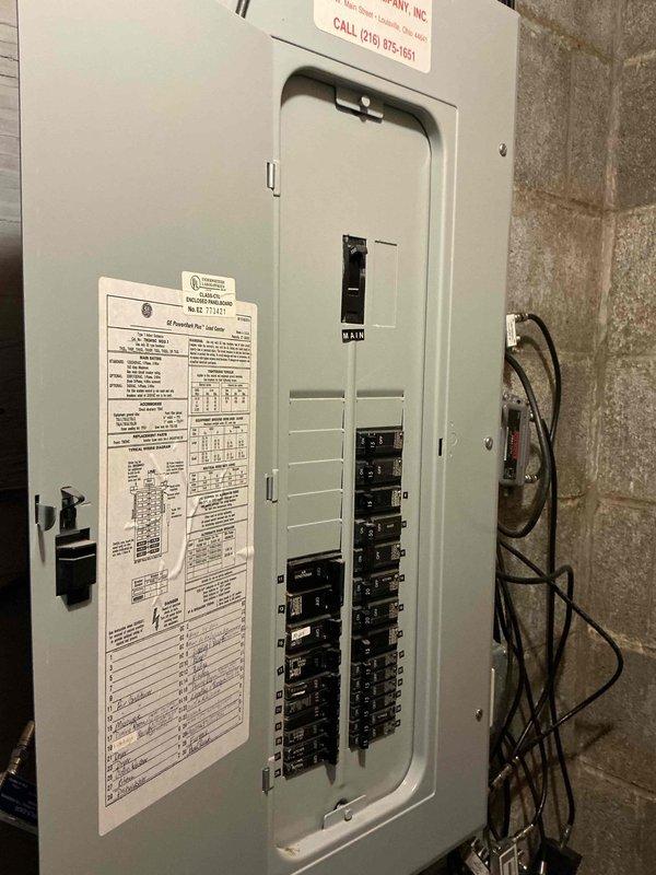 Conducted estimate for mini split installation in lower level music room. Assessed electrical panel capacity and circuit availability for new system installation, documented existing 200-amp service panel with available breaker positions. Evaluated installation location requirements and confirmed adequate wall space for indoor air handler unit placement above existing furnishings.