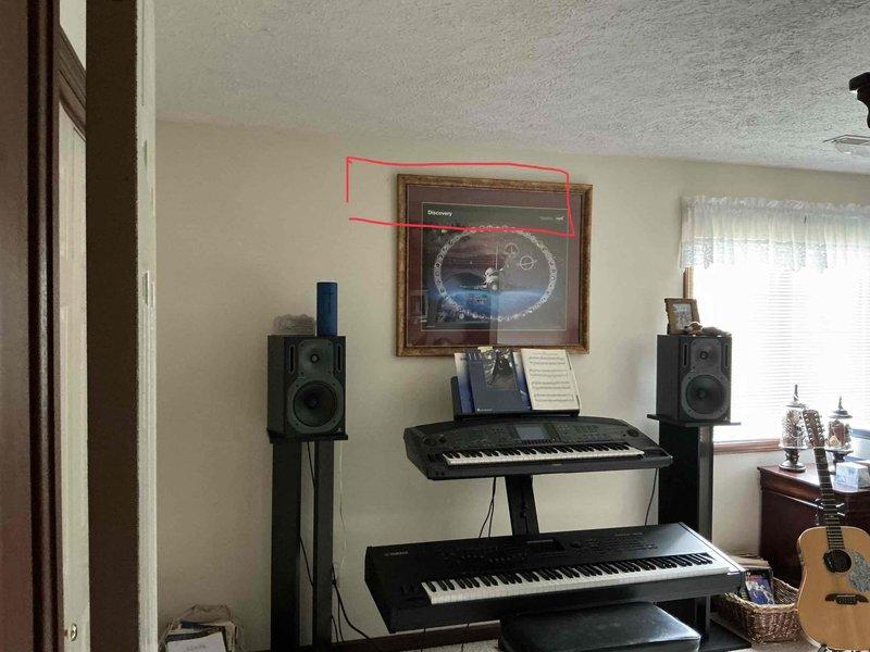 Conducted estimate for mini split installation in lower level music room. Assessed electrical panel capacity and circuit availability for new system installation, documented existing 200-amp service panel with available breaker positions. Evaluated installation location requirements and confirmed adequate wall space for indoor air handler unit placement above existing furnishings.