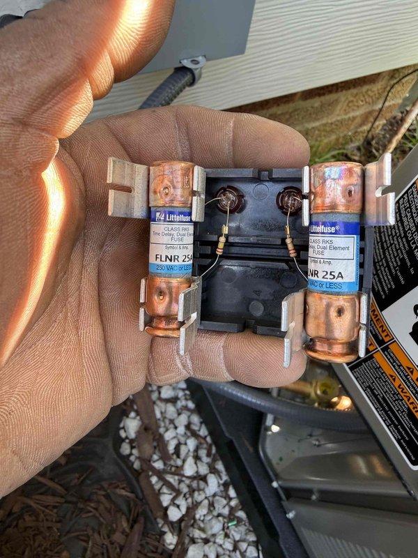 Completed installation of outdoor HVAC unit with proper electrical disconnect and fuse assembly, verifying 25A time-delay fuses are correctly installed and operational. Addressed caulking deficiencies and cosmetic dent on furnace cabinet, ensuring all penetrations are properly sealed and unit meets manufacturer specifications for indoor installation with refrigerant line connections secured and condensate drainage system in place.