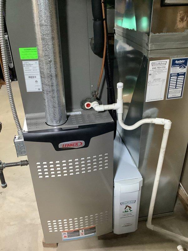 Completed scheduled cooling maintenance on 6-year-old HVAC system. Inspected outdoor condenser unit and found moderate accumulation of dust, debris, and organic material on heat exchanger fins. Verified indoor Lennox furnace and air handler components, checked PVC condensate drain lines and connections for proper operation. All system components operational and functioning within normal parameters.