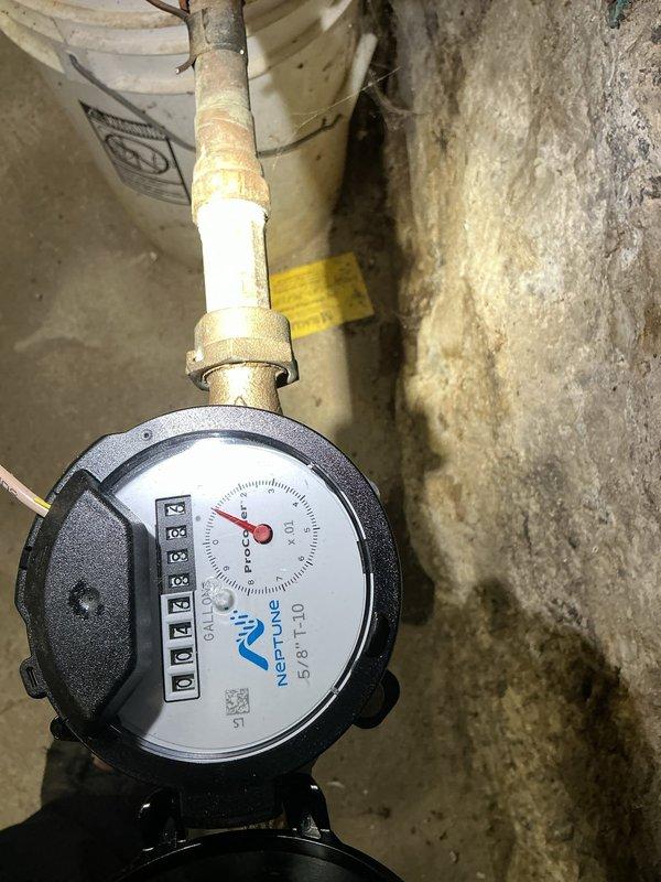 Completed routine backflow prevention device testing at a 160-year-old single-family residence. Inspected and tested the backflow preventer assembly located in the basement utility area near the Neptune water meter. Device showed proper operation with no cross-connection issues detected. Verified that the backflow assembly maintained appropriate pressure differential and check valves sealed correctly during testing procedures. Documented existing conditions of aging plumbing infrastructure, including copper piping with mineral deposits and corrosion typical of historic residential systems. All components passed testing requirements and system remains compliant with current plumbing codes.