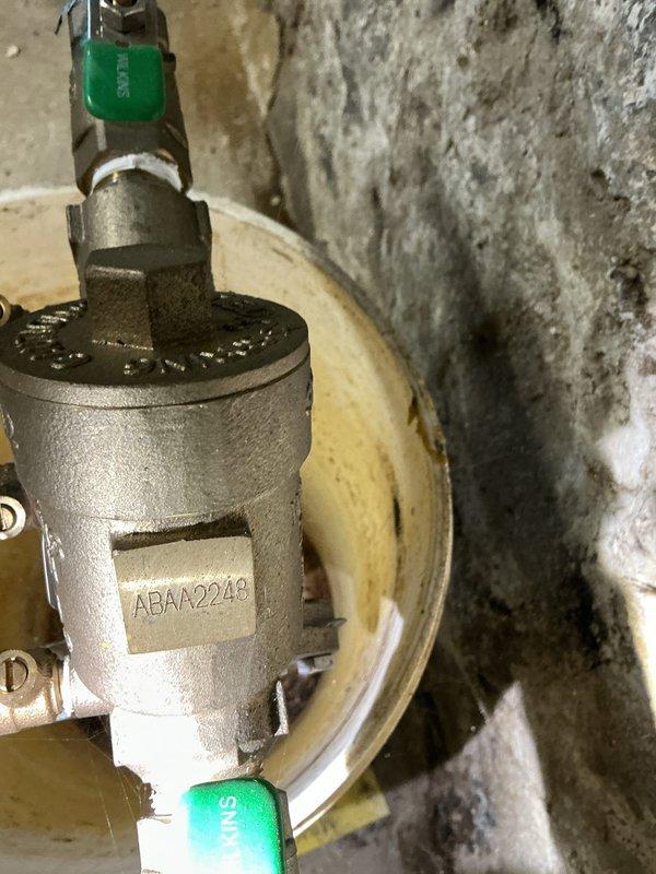 Completed routine backflow prevention device testing at a 160-year-old single-family residence. Inspected and tested the backflow preventer assembly located in the basement utility area near the Neptune water meter. Device showed proper operation with no cross-connection issues detected. Verified that the backflow assembly maintained appropriate pressure differential and check valves sealed correctly during testing procedures. Documented existing conditions of aging plumbing infrastructure, including copper piping with mineral deposits and corrosion typical of historic residential systems. All components passed testing requirements and system remains compliant with current plumbing codes.